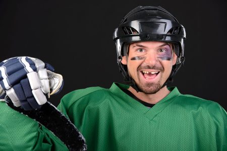 Hockey player with a missing tooth.